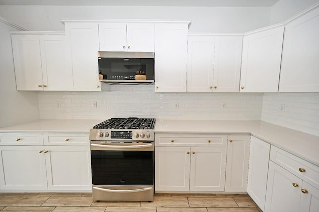kitchen featuring light countertops, appliances with stainless steel finishes, and white cabinetry