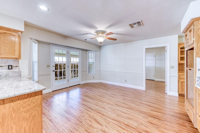 301 W Paul Ave, Clovis, CA 93612 - unfurnished living room with a ceiling fan, baseboards, visible vents, and light wood-style floors