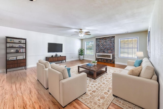 301 W Paul Ave, Clovis, CA 93612 - living room featuring baseboards, a ceiling fan, and light wood finished floors