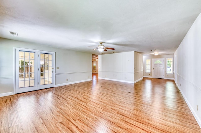 301 W Paul Ave, Clovis, CA 93612 - unfurnished living room with a ceiling fan, baseboards, visible vents, and light wood-style floors