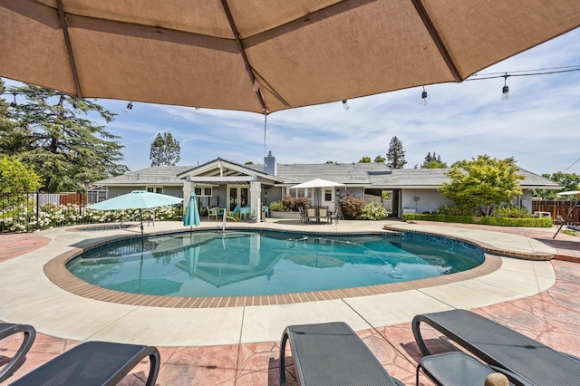 view of pool with fence, a fenced in pool, and a patio