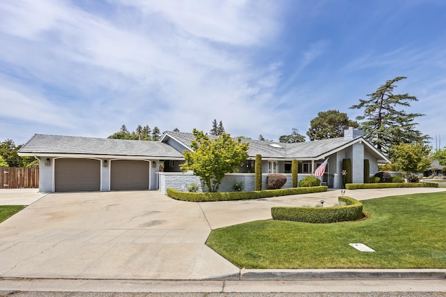 ranch-style house featuring a front lawn, fence, stucco siding, an attached garage, and driveway