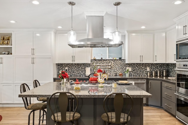 2315 W Celeste Ave, Fresno, CA 93711 - kitchen featuring island exhaust hood, appliances with stainless steel finishes, recessed lighting, and white cabinetry