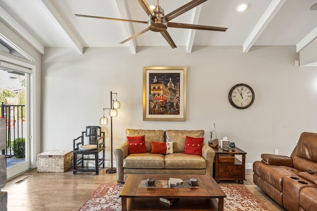 living room with beam ceiling, a ceiling fan, baseboards, wood finished floors, and visible vents