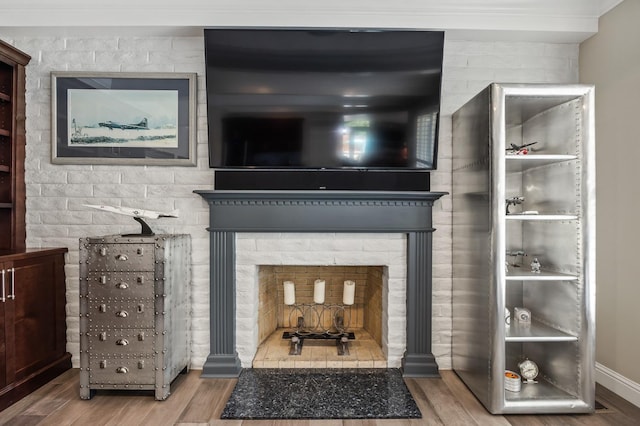 interior details featuring crown molding and wood finished floors