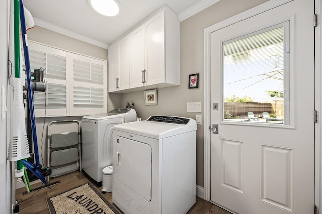 washroom featuring ornamental molding, cabinet space, independent washer and dryer, and wood finished floors