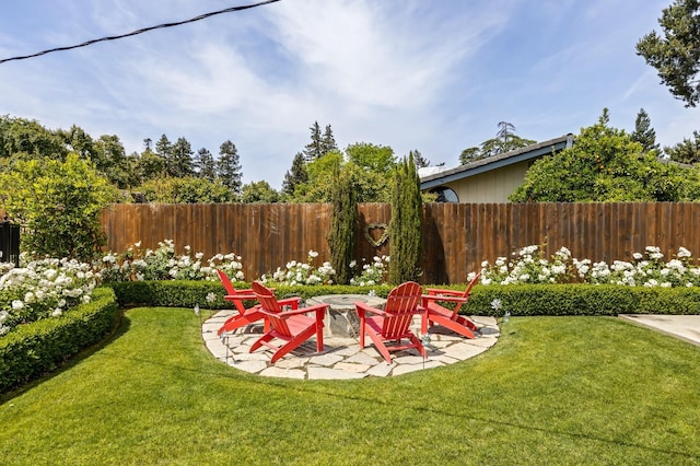 view of yard featuring a fenced backyard, an outdoor fire pit, and a patio area