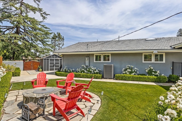 2315 W Celeste Ave, Fresno, CA 93711 - back of property with stucco siding, a fire pit, cooling unit, a patio, and a gate