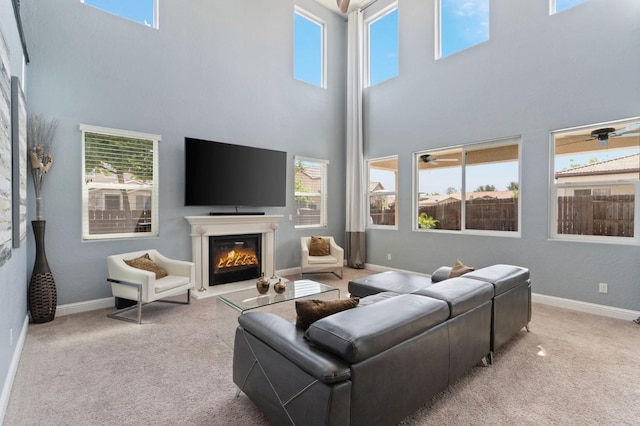 3772 Wrenwood Ave, Clovis, CA 93619 - carpeted living area featuring a healthy amount of sunlight, a towering ceiling, and a glass covered fireplace