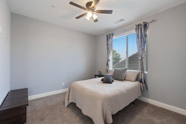 carpeted bedroom with baseboards, ceiling fan, and visible vents