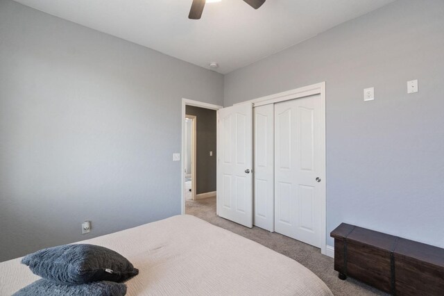 bedroom with a closet, a ceiling fan, carpet, and baseboards