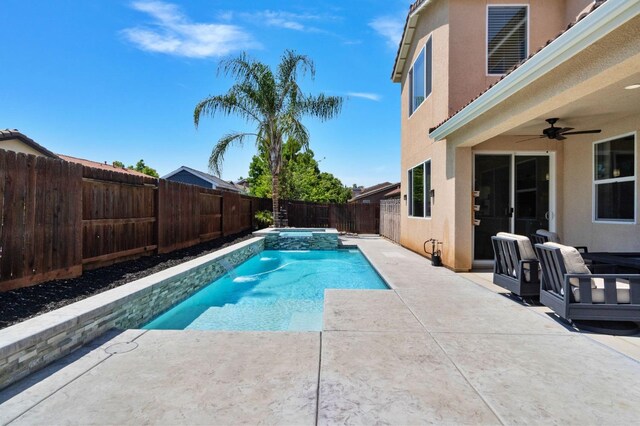 view of swimming pool with a fenced backyard, a ceiling fan, a patio, and a pool with connected hot tub
