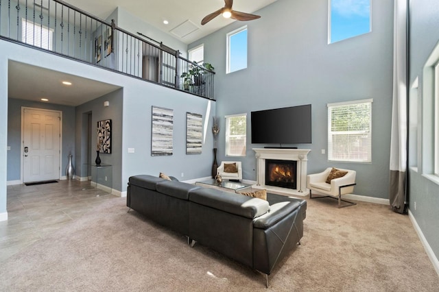 3772 Wrenwood Ave, Clovis, CA 93619 - carpeted living room featuring recessed lighting, ceiling fan, a lit fireplace, a high ceiling, and baseboards