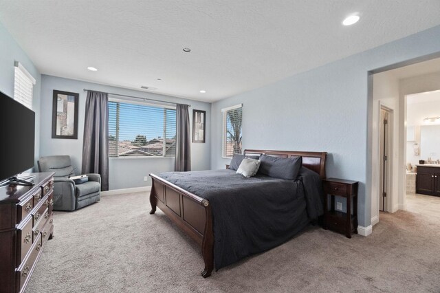bedroom featuring baseboards, recessed lighting, and light carpet