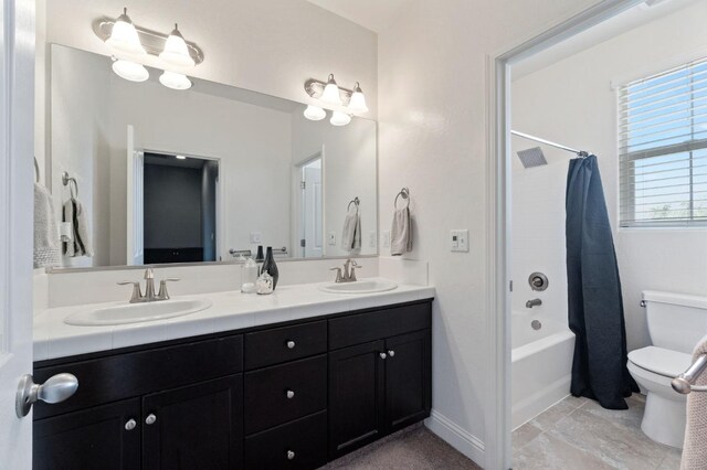 full bath with double vanity, a sink, shower / bathtub combination with curtain, and toilet