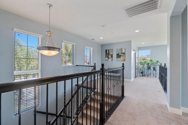 hall with carpet floors, recessed lighting, baseboards, an upstairs landing, and visible vents