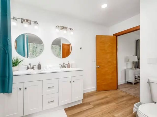 56406 Marina View Way, Bass Lake, CA 93604 - bathroom with a sink, double vanity, toilet, and wood finished floors