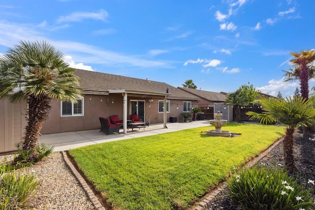 back of property with fence, stucco siding, a patio area, a tiled roof, and a yard