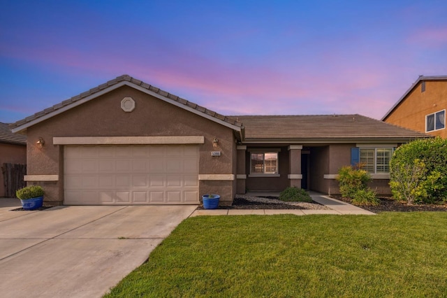 ranch-style home with driveway, a tile roof, a garage, a front lawn, and stucco siding