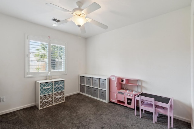 playroom with a ceiling fan, baseboards, visible vents, and dark colored carpet
