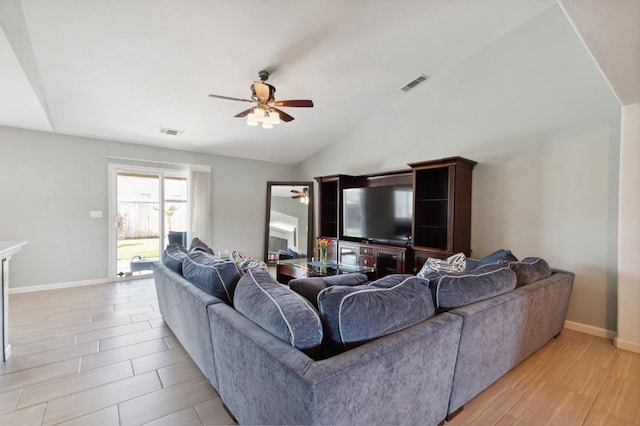 living area with baseboards, ceiling fan, lofted ceiling, and visible vents