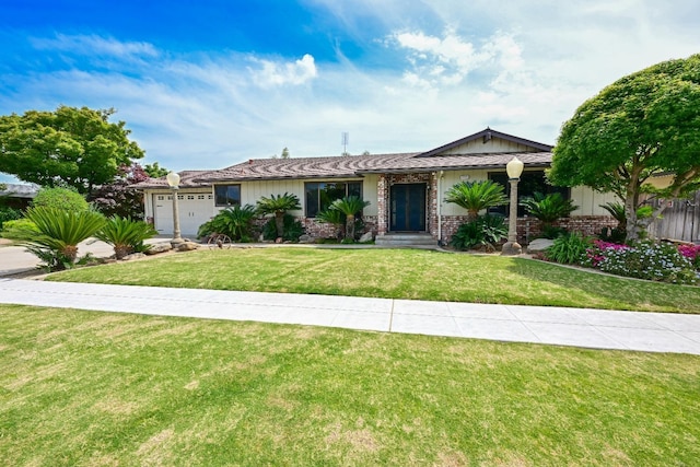 ranch-style home with brick siding, a garage, and a front lawn