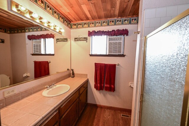 full bathroom featuring wood ceiling, visible vents, an enclosed shower, wood finished floors, and vanity