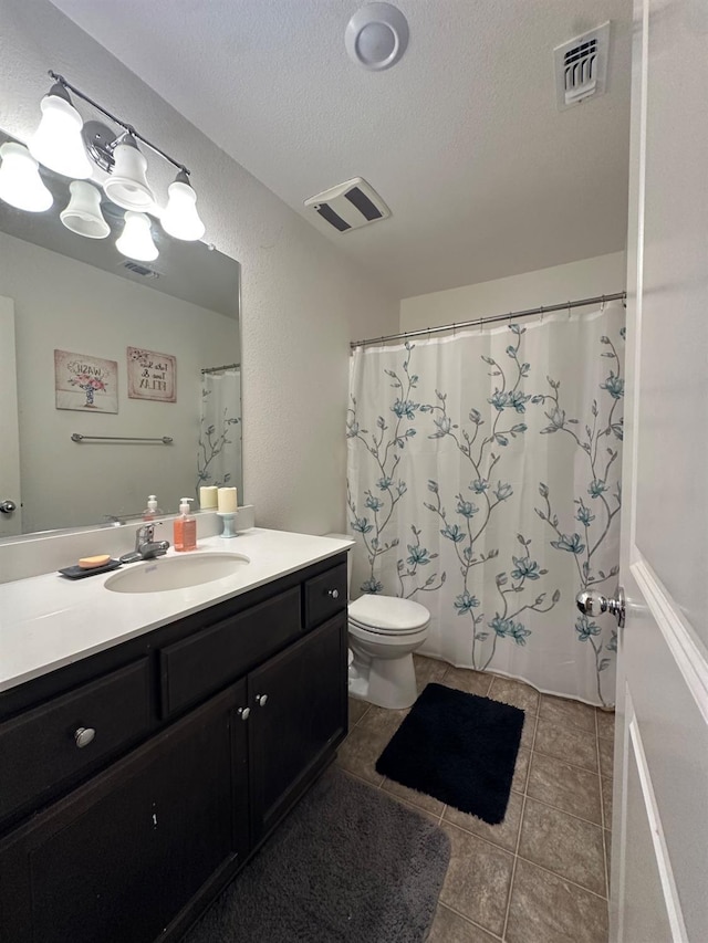 628 Marcus Ave, Merced, CA 95341 - bathroom with a textured ceiling, visible vents, tile patterned flooring, vanity, and toilet