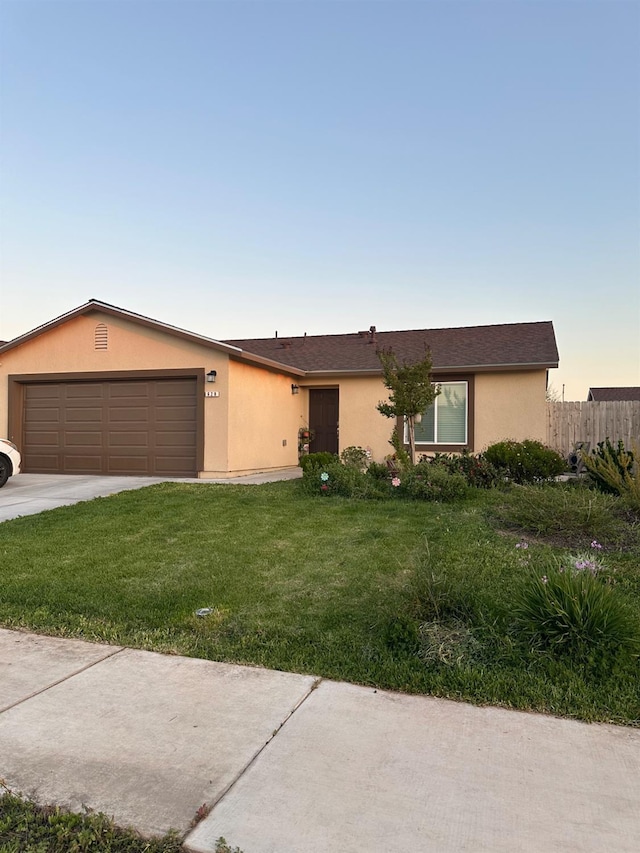 628 Marcus Ave, Merced, CA 95341 - ranch-style home featuring a garage, fence, a front yard, stucco siding, and concrete driveway