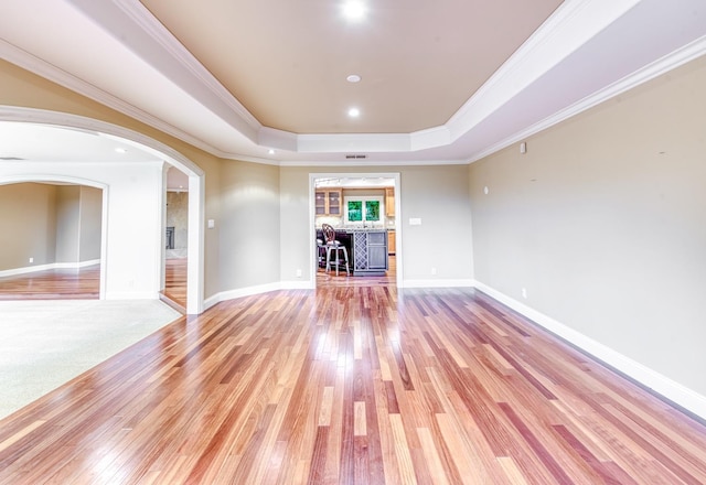 1409 W Big Sandy Rd, Fresno, CA 93711 - spare room with ornamental molding, a tray ceiling, and light wood-type flooring