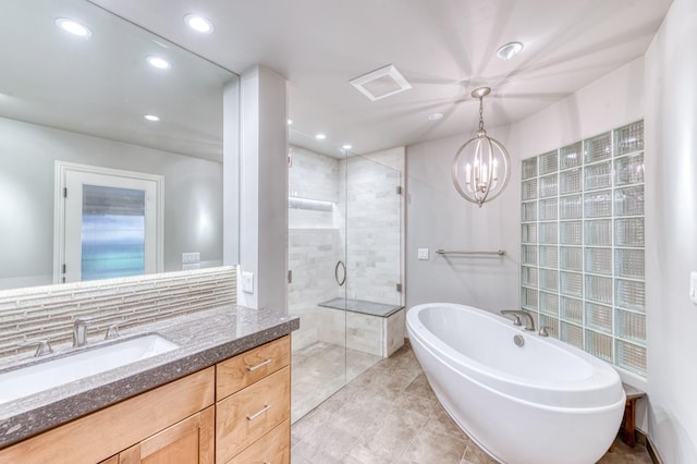 1409 W Big Sandy Rd, Fresno, CA 93711 - full bathroom featuring a notable chandelier, vanity, recessed lighting, a soaking tub, and a stall shower