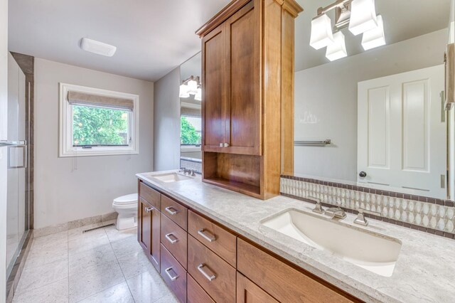 1409 W Big Sandy Rd, Fresno, CA 93711 - bathroom featuring a sink, baseboards, toilet, and double vanity