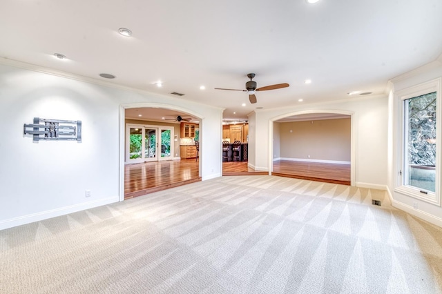 1409 W Big Sandy Rd, Fresno, CA 93711 - unfurnished living room featuring light carpet, baseboards, recessed lighting, arched walkways, and a ceiling fan
