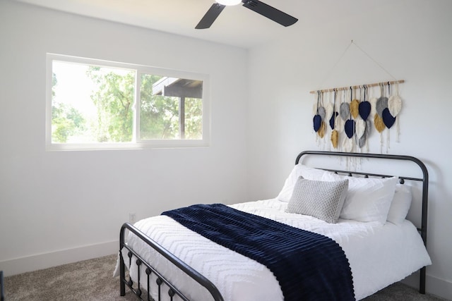 carpeted bedroom with baseboards and ceiling fan