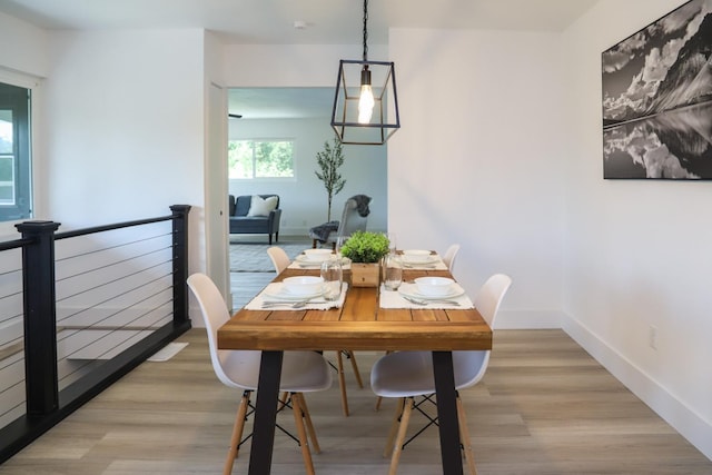 dining room featuring light wood-style floors and baseboards