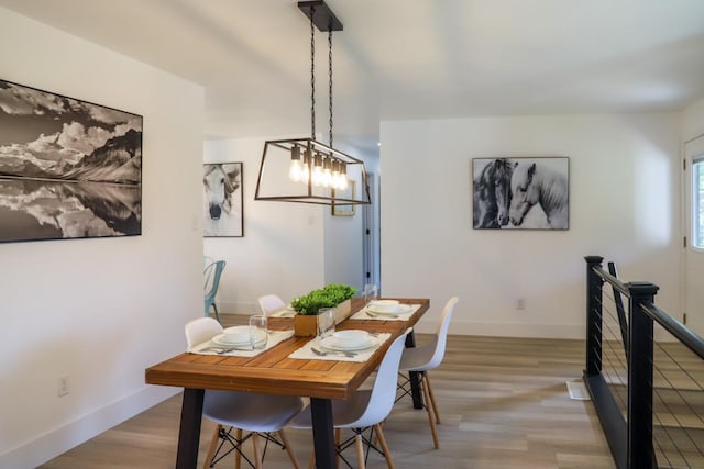 dining room featuring baseboards and light wood finished floors