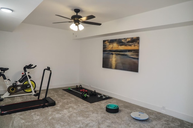 exercise room with carpet floors, ceiling fan, and baseboards