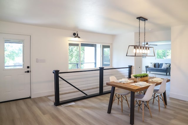 dining room with baseboards, visible vents, and light wood-type flooring