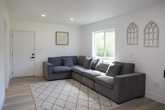 living room with recessed lighting, light wood finished floors, and baseboards