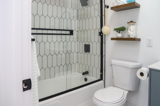 bathroom featuring toilet, bath / shower combo with glass door, and vanity
