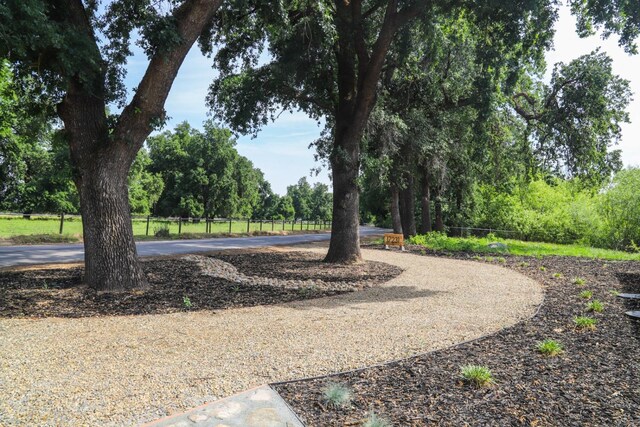 surrounding community with fence and curved driveway