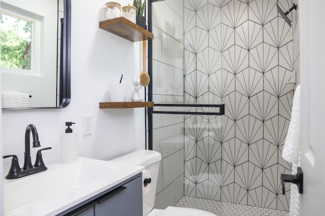 bathroom featuring vanity, toilet, and a stall shower