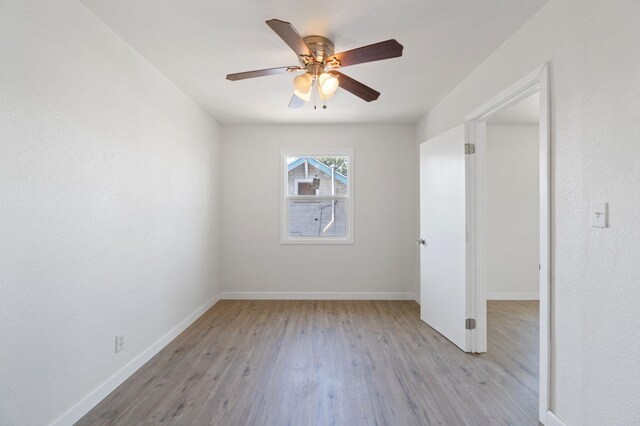 2521 E Washington Ave, Fresno, CA 93701 - spare room featuring baseboards, ceiling fan, and wood finished floors