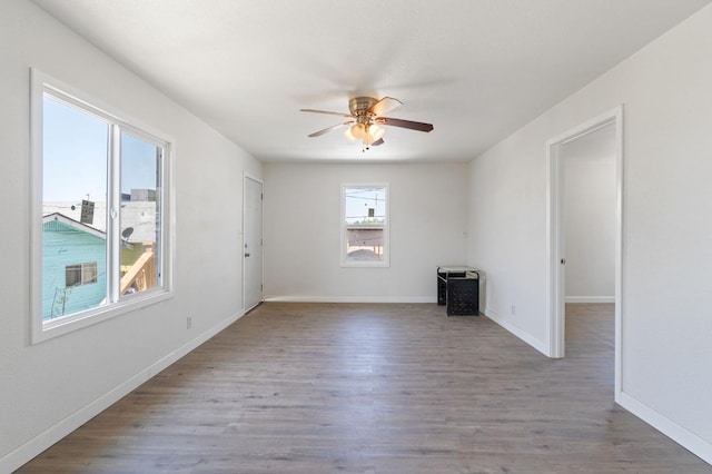 2521 E Washington Ave, Fresno, CA 93701 - empty room with baseboards, ceiling fan, and wood finished floors
