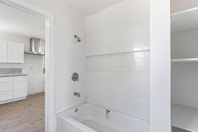 2521 E Washington Ave, Fresno, CA 93701 - bathroom featuring vanity,  shower combination, and wood finished floors