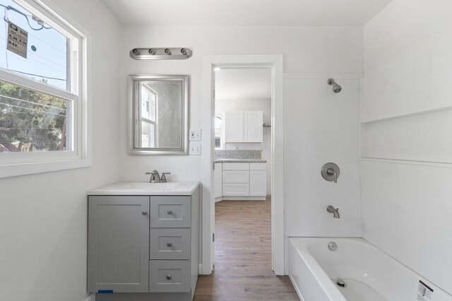 2521 E Washington Ave, Fresno, CA 93701 - full bath featuring vanity, washtub / shower combination, and wood finished floors