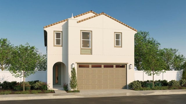 mediterranean / spanish-style home with fence, stucco siding, and concrete driveway