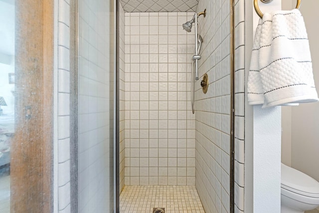 full bath featuring a stall shower and toilet