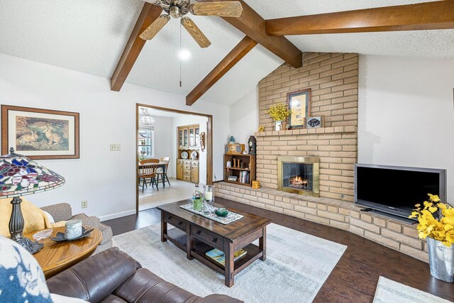 943 E Goshen Ave, Fresno, CA 93720 - living room with wood finished floors, ceiling fan, and a fireplace