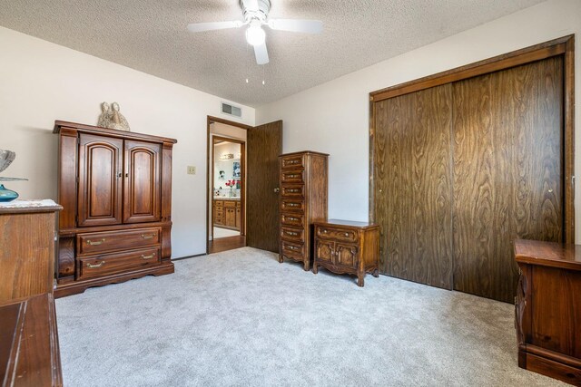 943 E Goshen Ave, Fresno, CA 93720 - bedroom with a textured ceiling, carpet flooring, a closet, and ceiling fan